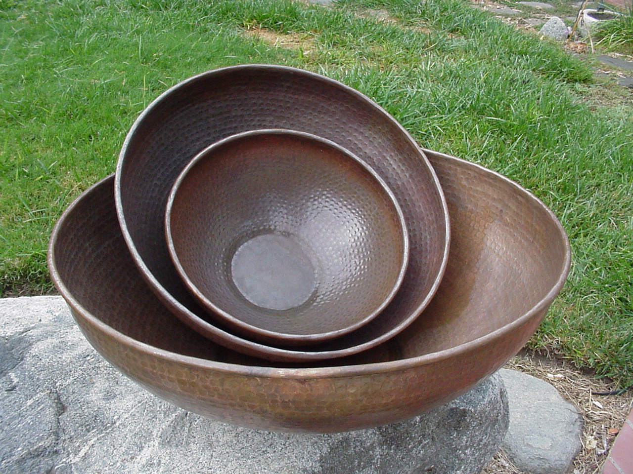 Copper Basins in Different Sized on a Concrete Slab