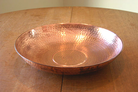 A Round Copper Dish With a Round Bottom